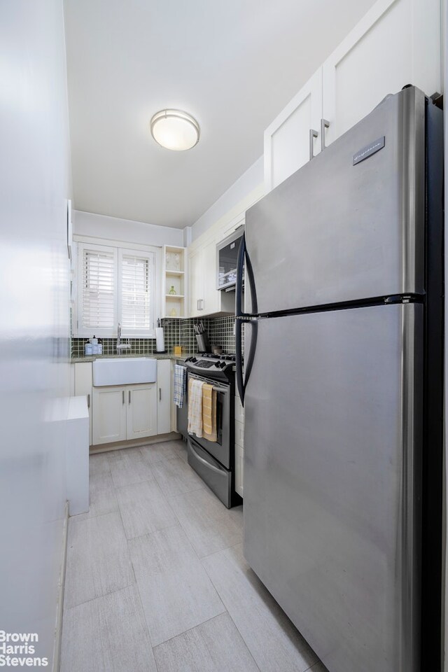 166 E 35th St Unit 10G, New York City, NY 10016 - kitchen with appliances with stainless steel finishes, white cabinetry, tasteful backsplash, and open shelves