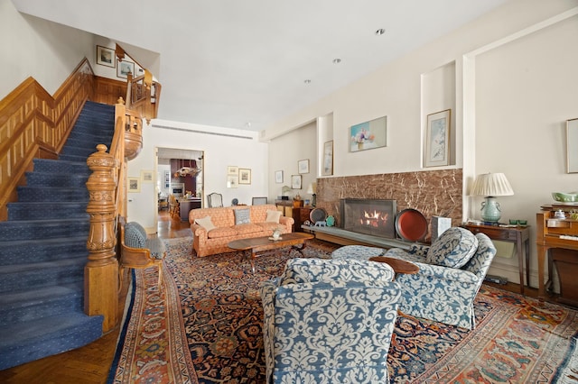 living room featuring stairs and a premium fireplace