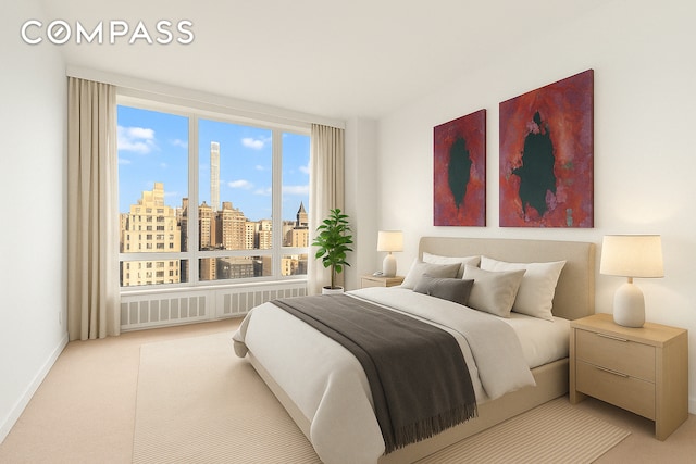 bedroom with a view of city, radiator, light carpet, and baseboards
