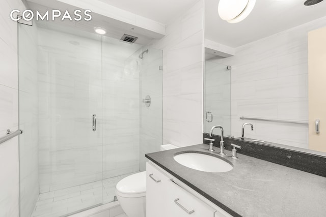 full bath with visible vents, a stall shower, toilet, and vanity