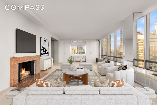 living area with expansive windows, a fireplace, and plenty of natural light