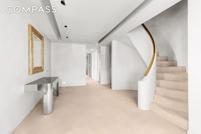 interior space featuring carpet and baseboards