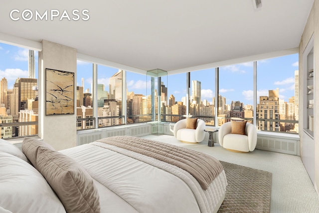 carpeted bedroom with a view of city and visible vents