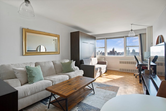 living area featuring baseboards and radiator heating unit