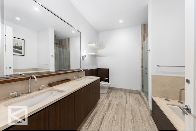 full bath with double vanity, toilet, a shower stall, and a sink