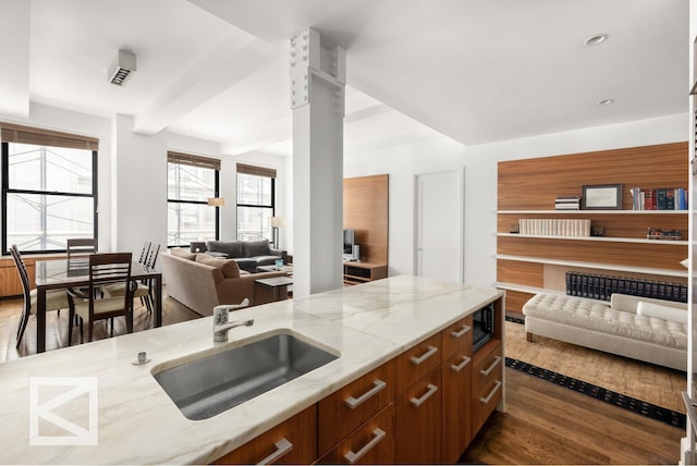 kitchen with open shelves, modern cabinets, a sink, and high quality appliances