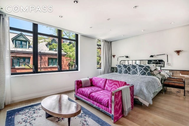 bedroom featuring baseboards and wood finished floors