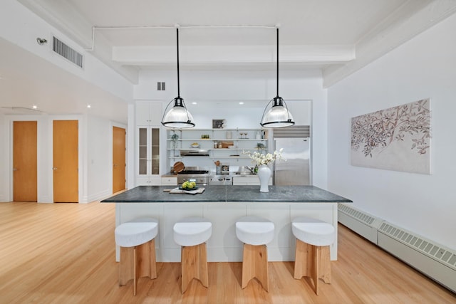 kitchen with open shelves, visible vents, premium appliances, beamed ceiling, and a baseboard heating unit