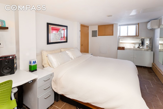 bedroom with an AC wall unit, dark tile patterned floors, and electric panel