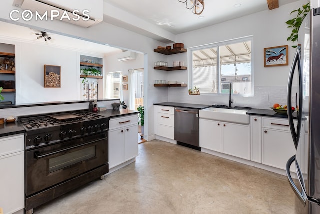 kitchen with dark countertops, appliances with stainless steel finishes, white cabinetry, open shelves, and a sink