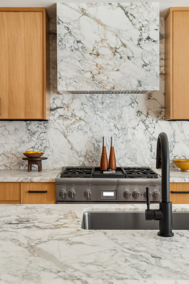126 Washington Ave, New York City, NY 11205 - kitchen with decorative backsplash, light stone countertops, and brown cabinetry