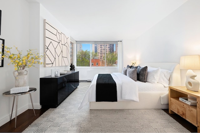 bedroom featuring baseboards and wood finished floors