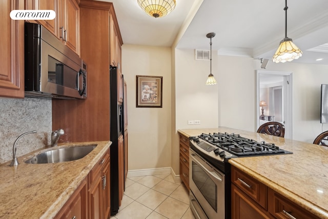 kitchen featuring stainless steel appliances, a sink, visible vents, backsplash, and light stone countertops