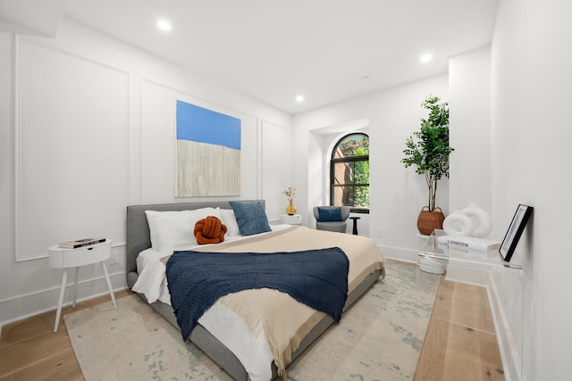 bedroom with recessed lighting, baseboards, and wood finished floors