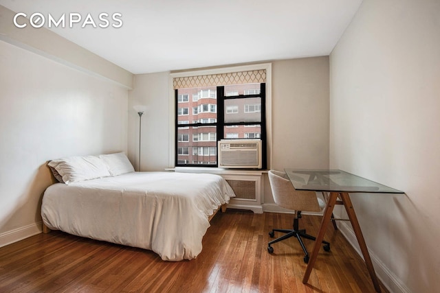 305 E 72nd St Unit 4Cn, New York City, NY 10021 - bedroom featuring baseboards, cooling unit, and hardwood / wood-style floors
