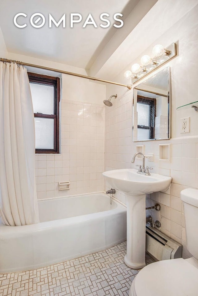 305 E 72nd St Unit 4Cn, New York City, NY 10021 - full bathroom with tile patterned floors, shower / tub combo with curtain, tile walls, and toilet