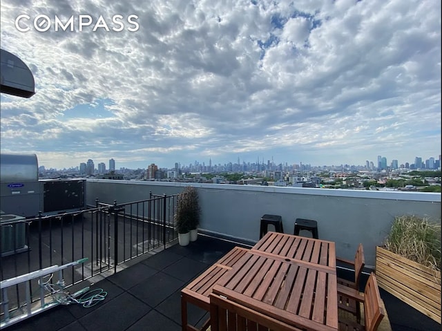 view of patio with a city view and a balcony