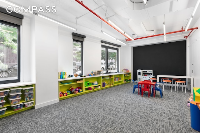 playroom with baseboards and carpet flooring