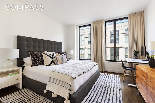 bedroom with baseboards and wood finished floors