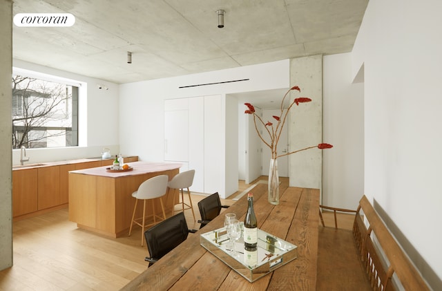 dining area with light wood-type flooring and visible vents