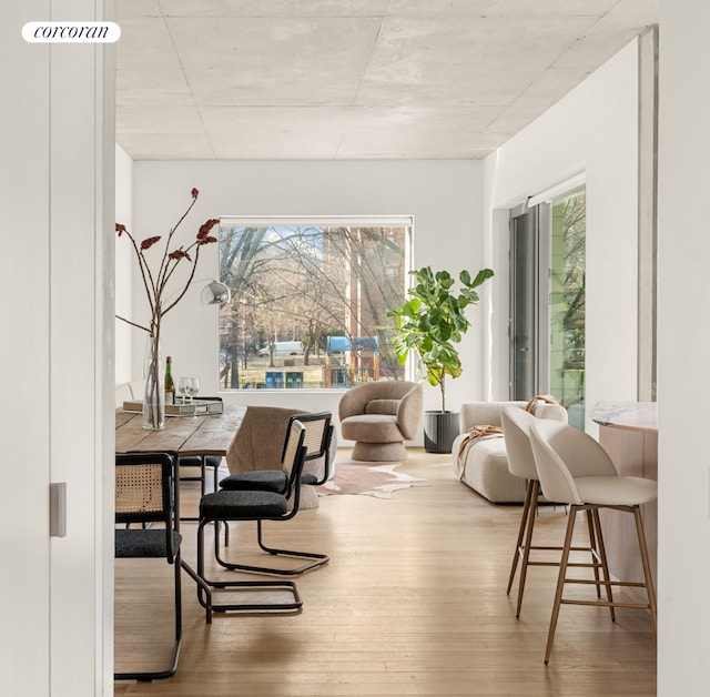 dining space with wood finished floors