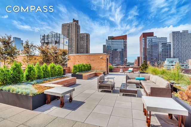 view of patio featuring outdoor lounge area and a city view