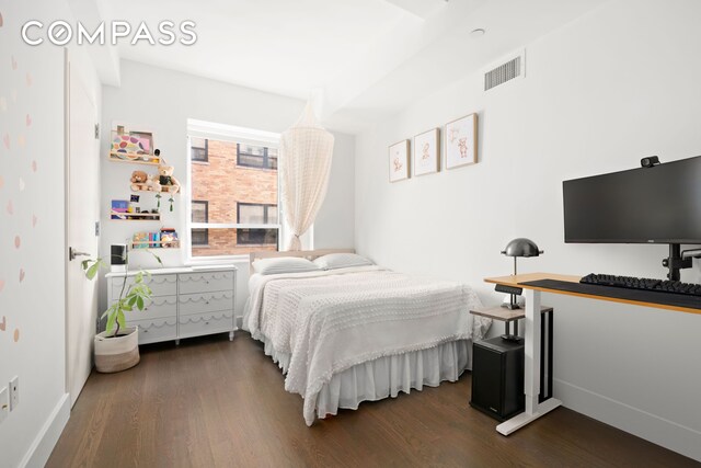 bedroom with visible vents, dark wood finished floors, and baseboards