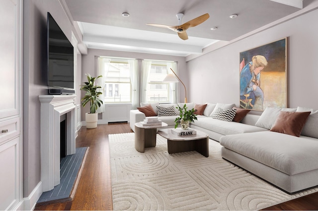 living room with a fireplace, ceiling fan, and wood finished floors