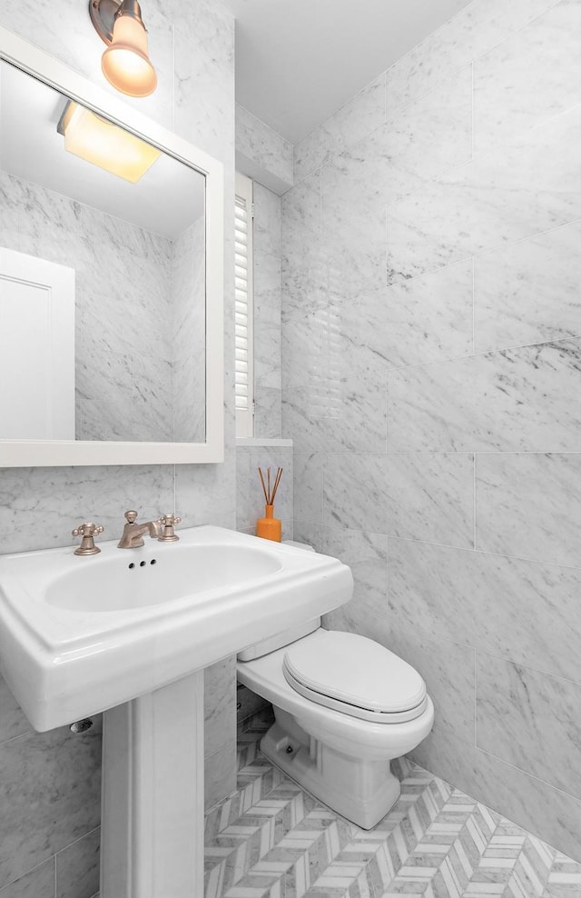 130 E 75th St Unit 5A, New York City, NY 10021 - half bathroom with tile walls and toilet