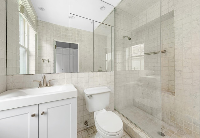 full bathroom featuring toilet, a shower stall, and tile walls