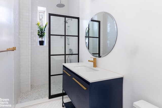 bathroom featuring vanity, toilet, and walk in shower