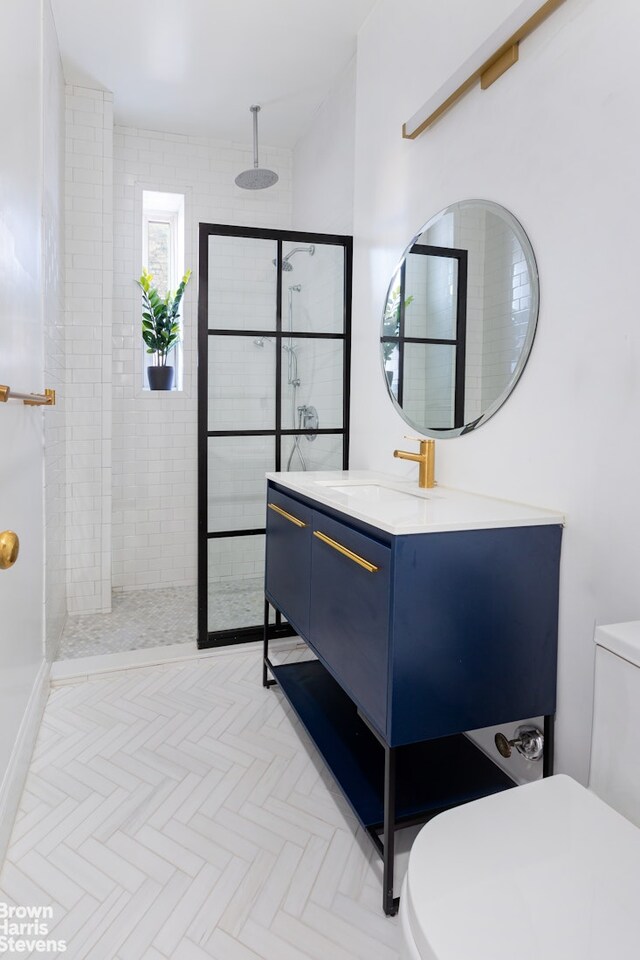 bathroom featuring vanity, walk in shower, and toilet