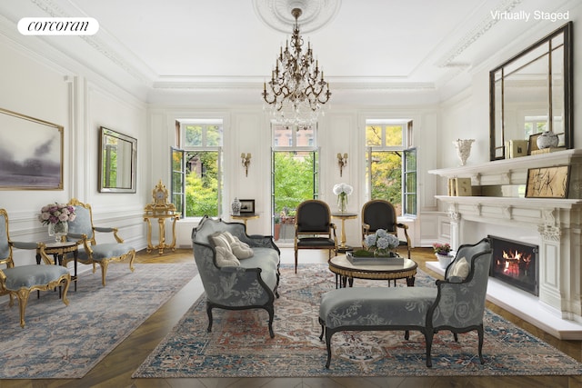 sitting room with a warm lit fireplace, plenty of natural light, visible vents, and a decorative wall