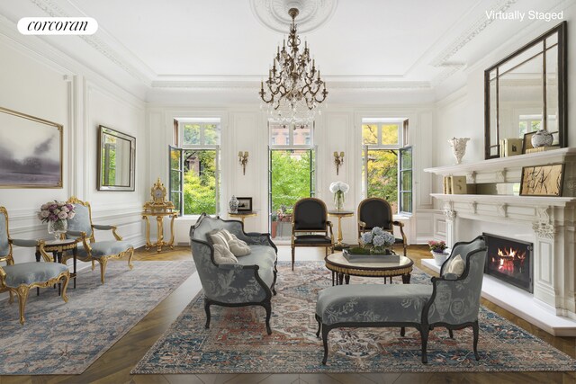 sitting room with a warm lit fireplace, plenty of natural light, visible vents, and a decorative wall