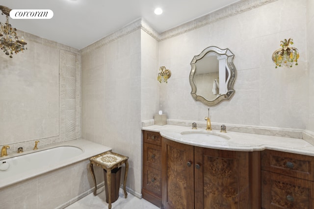 bathroom with a bathing tub, visible vents, tile walls, and vanity