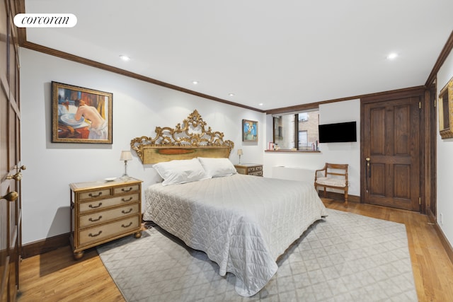 bedroom with baseboards, ornamental molding, visible vents, and light wood-style floors