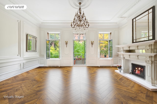 unfurnished living room featuring visible vents, a decorative wall, and a wealth of natural light