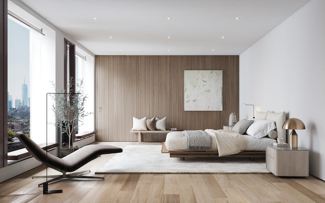 bedroom with recessed lighting, wood finished floors, and an accent wall