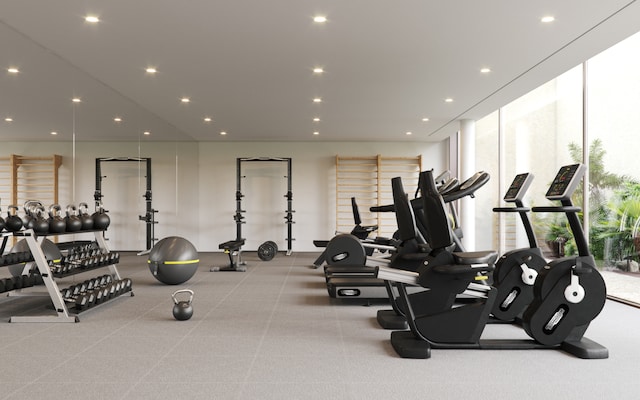 workout area with recessed lighting, plenty of natural light, and expansive windows