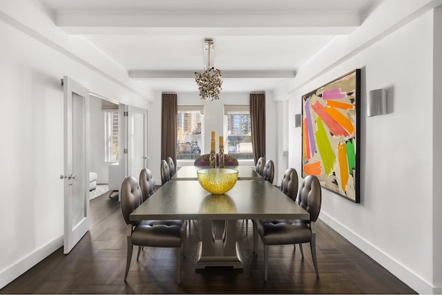 dining room with beamed ceiling, an inviting chandelier, and baseboards