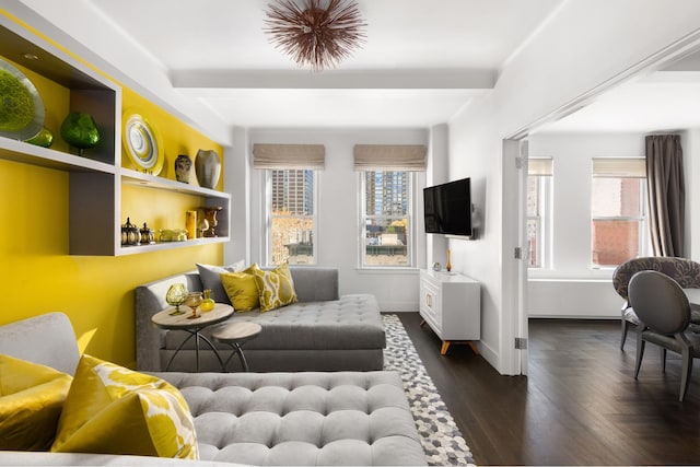 interior space with baseboards, wood finished floors, and beamed ceiling