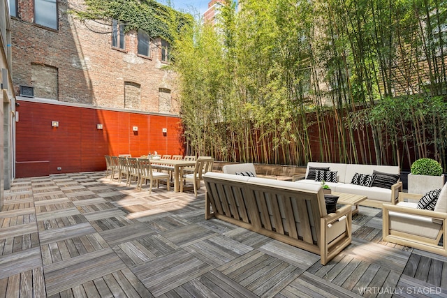 wooden terrace featuring an outdoor hangout area and outdoor dining space