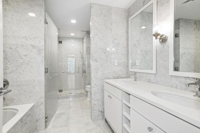 full bath with visible vents, a stall shower, a sink, and tile walls