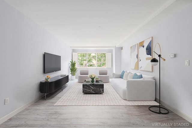 living room featuring wood finished floors and baseboards