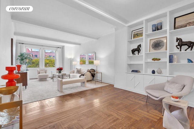 sitting room with built in features, baseboards, and visible vents