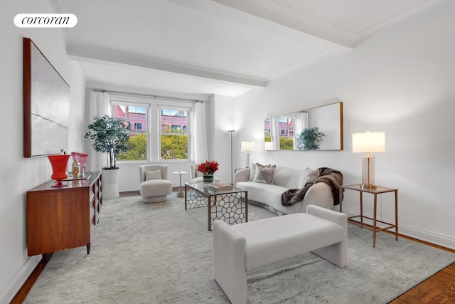 living area featuring beam ceiling, visible vents, and baseboards