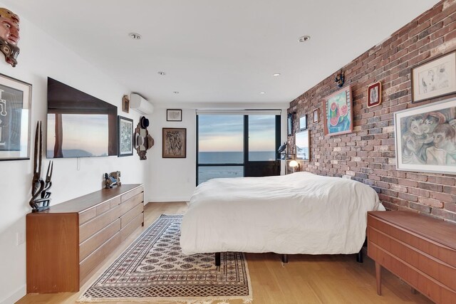 91-16 Shore Front Pkwy Unit 6H, New York City, NY 11693 - bedroom with brick wall, wood finished floors, recessed lighting, and baseboards