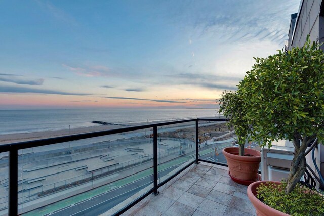 91-16 Shore Front Pkwy Unit 6H, New York City, NY 11693 - balcony at dusk with view of water and beach
