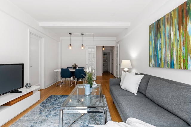 325 E 41st St Unit 806, New York City, NY 10017 - living area with wood finished floors and beamed ceiling