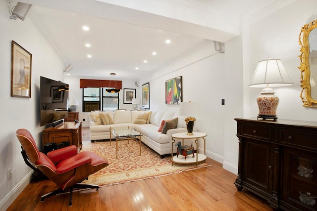 living area with light wood-style flooring, ornamental molding, baseboards, and recessed lighting